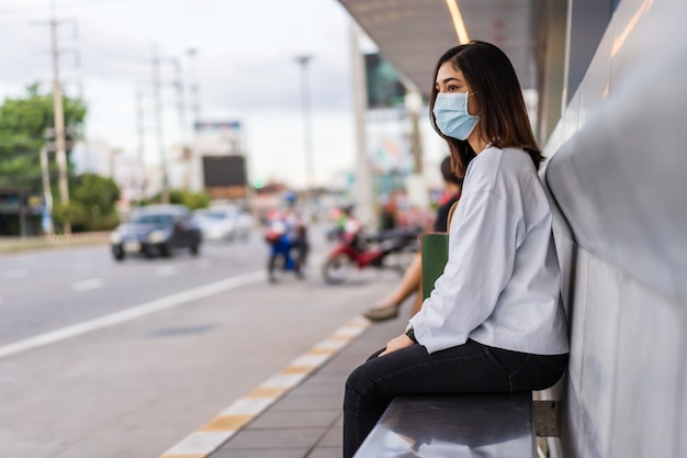 Woman waiting at bus stop